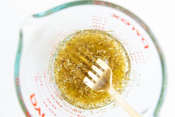 Greek salad dressing in a measuring cup.