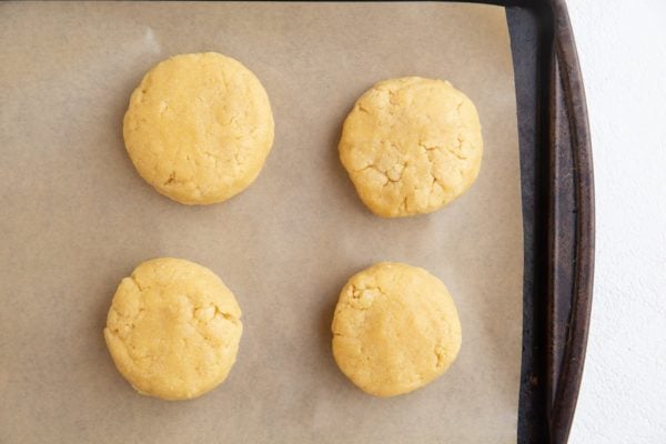 Four biscuits on a baking sheet