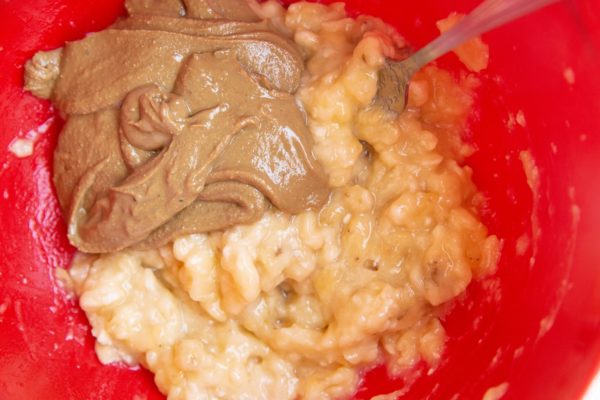 Peanut butter and mashed banana in a mixing bowl.
