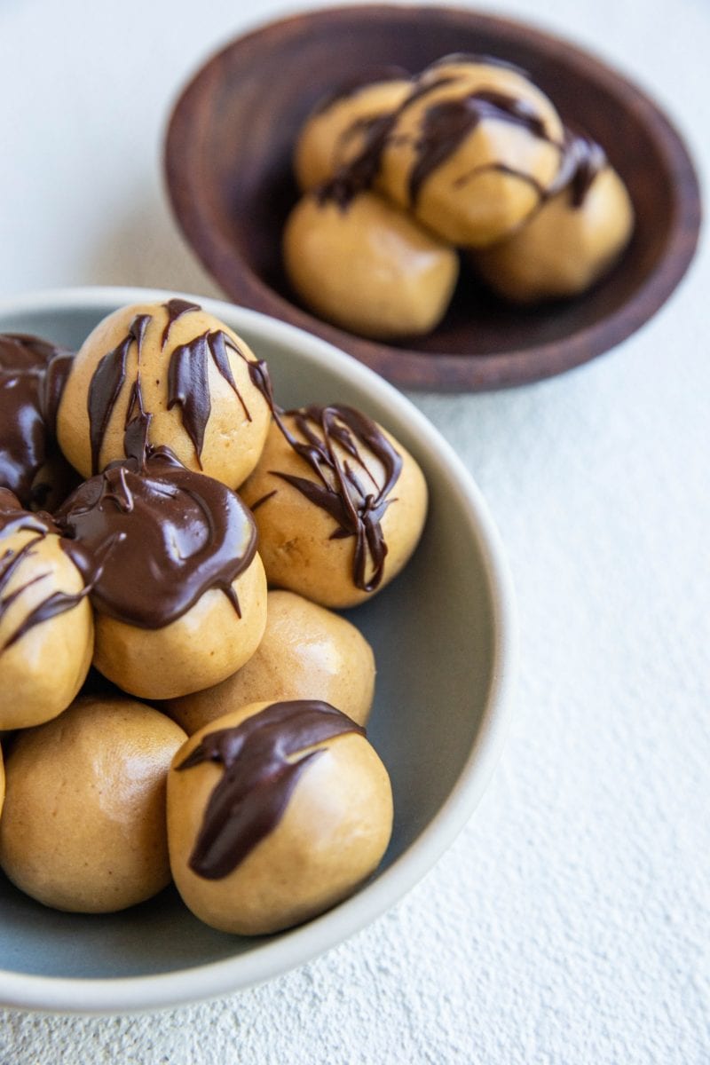 close up photo of peanut butter protein balls drizzled with chocolate