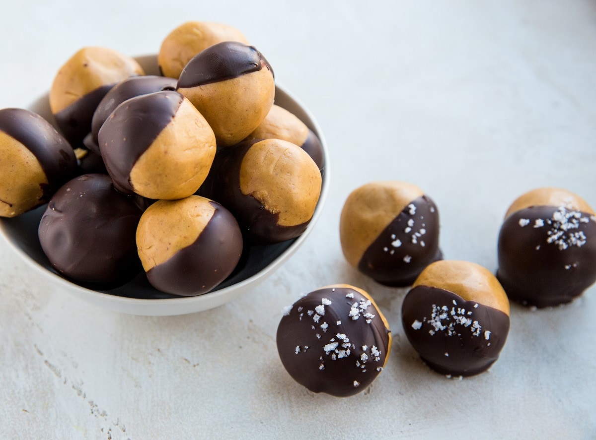 bowl of peanut butter balls with peanut butter balls to the side