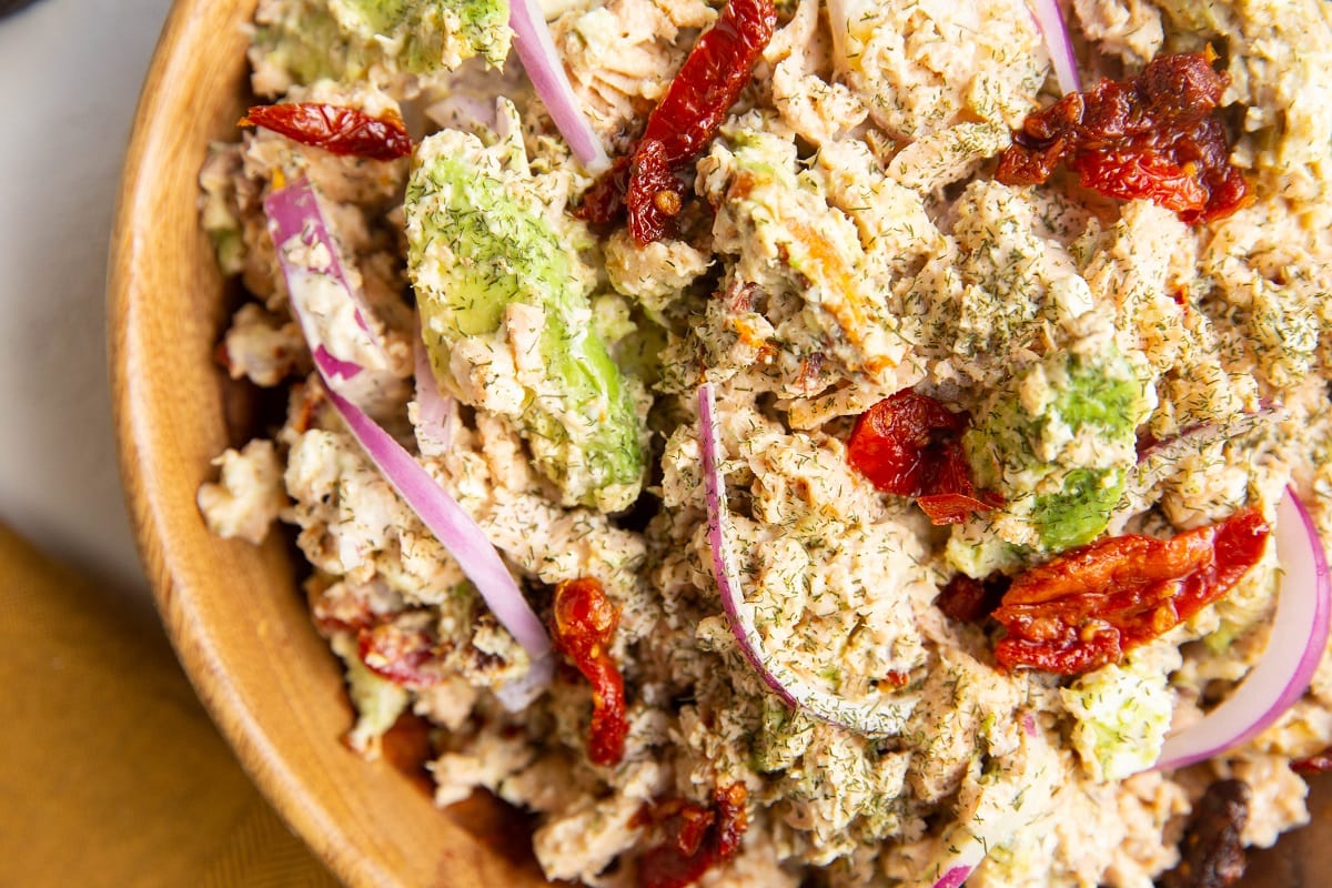 Mediterranean Salmon Avocado Salad in a wooden bowl