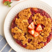 Strawberry crumb cake on a plate fresh out of the oven