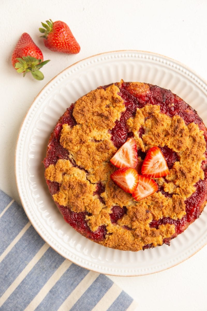 Strawberry crumb cake on a plate fresh out of the oven