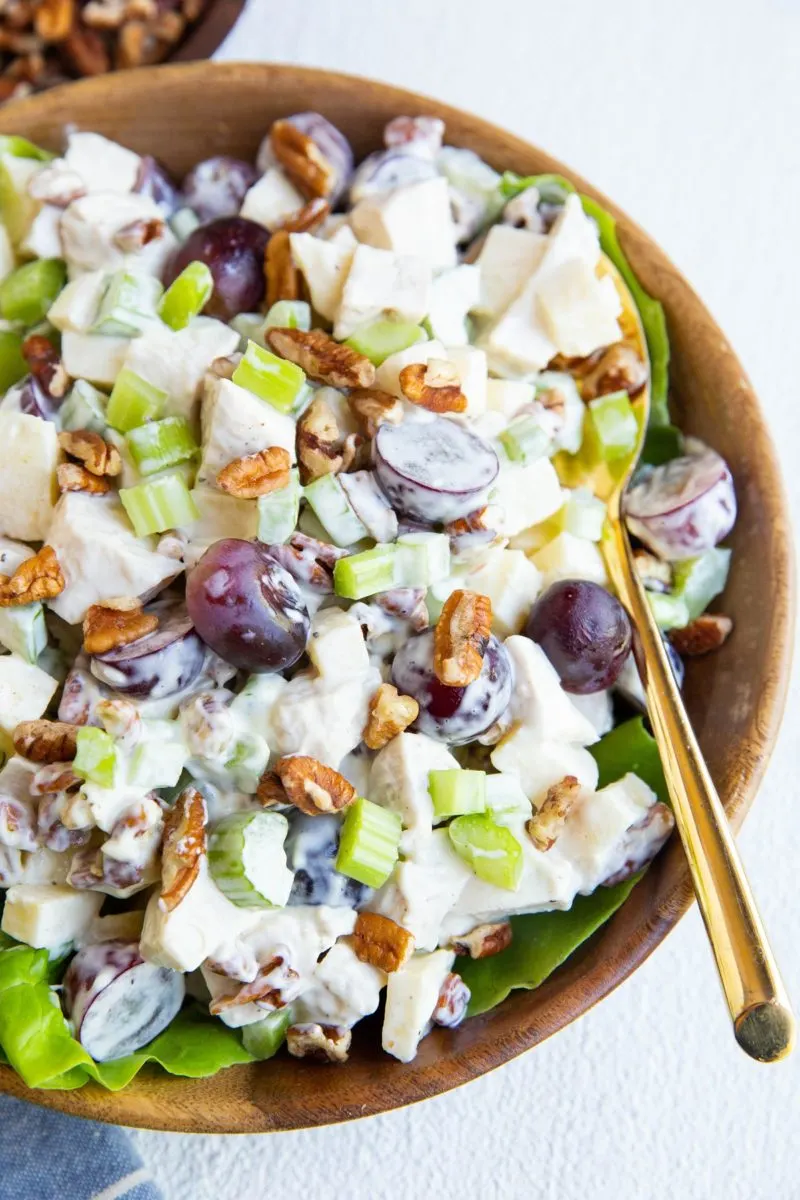 closeup image of Waldorf chicken salad in a wood bowl.