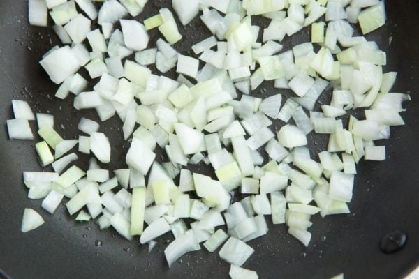 Onion sautéing in a skillet.