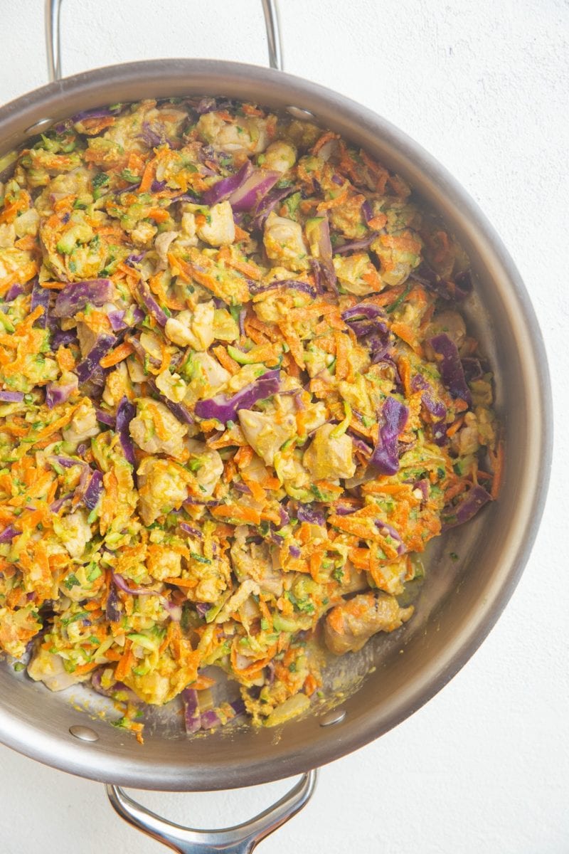 stainless steel skillet of chicken and vegetables