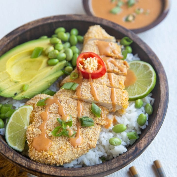 beautiful rice bowl with crispy japanese chicken, avocado and sauce