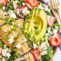 Wooden bowl of chicken salad with avocado