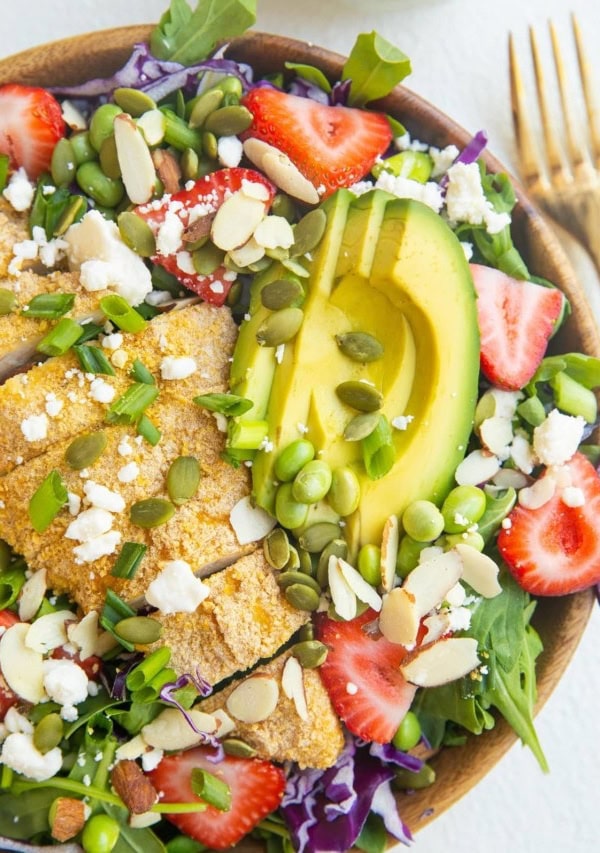 Wooden bowl of chicken salad with avocado