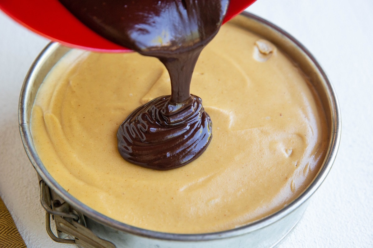 Pouring ganache over the peanut butter filling