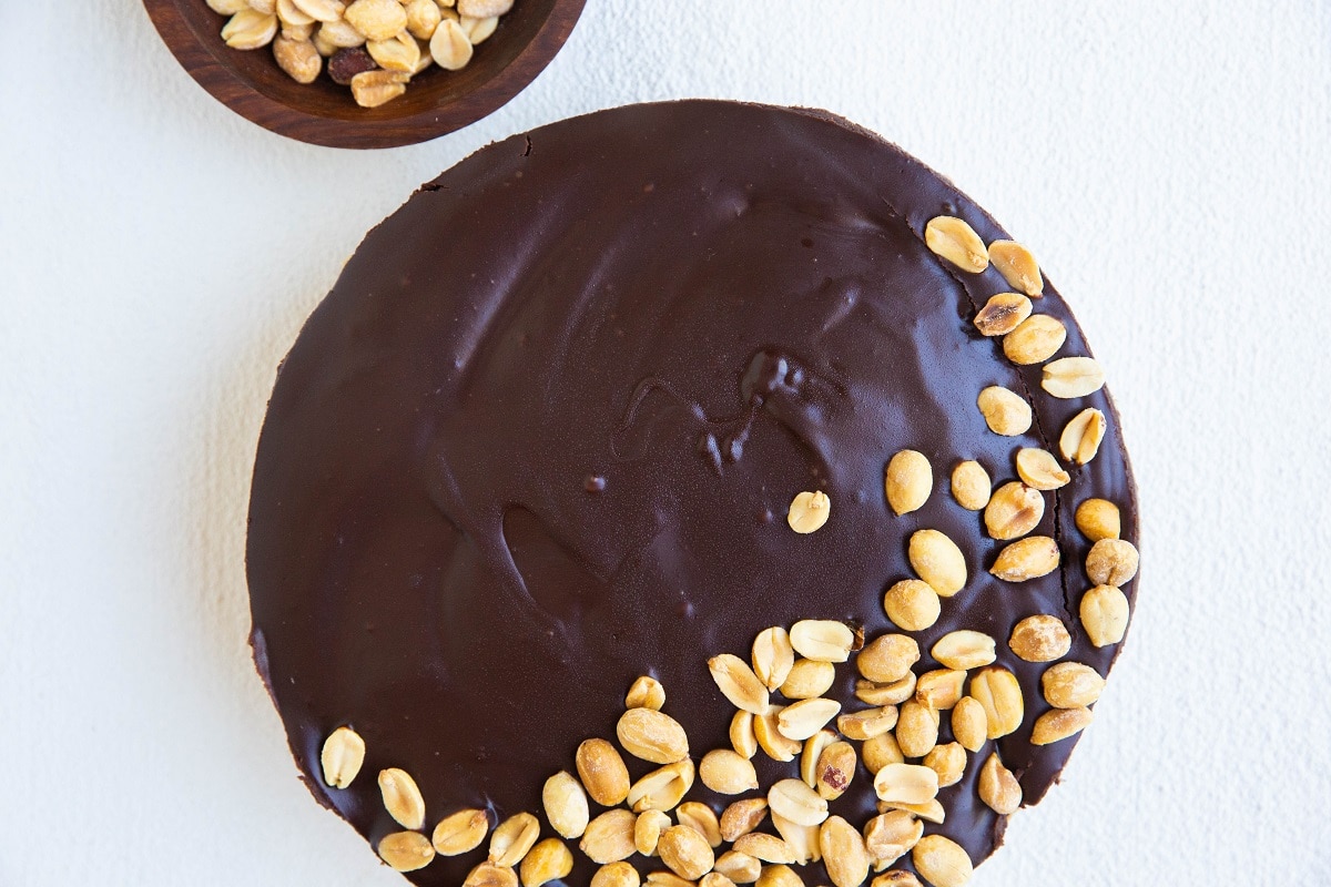 whole peanut butter pie with chocolate ganache and peanuts on top