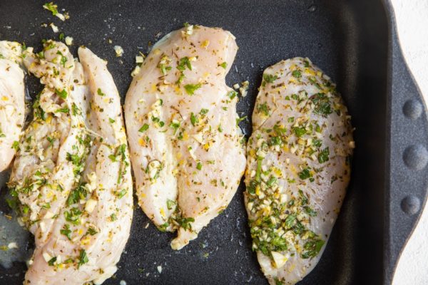 marinated chicken in a roasting pan