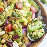 Wooden bowl of avocado chickpea cucumber salad