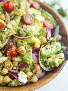 Wooden bowl of avocado chickpea cucumber salad