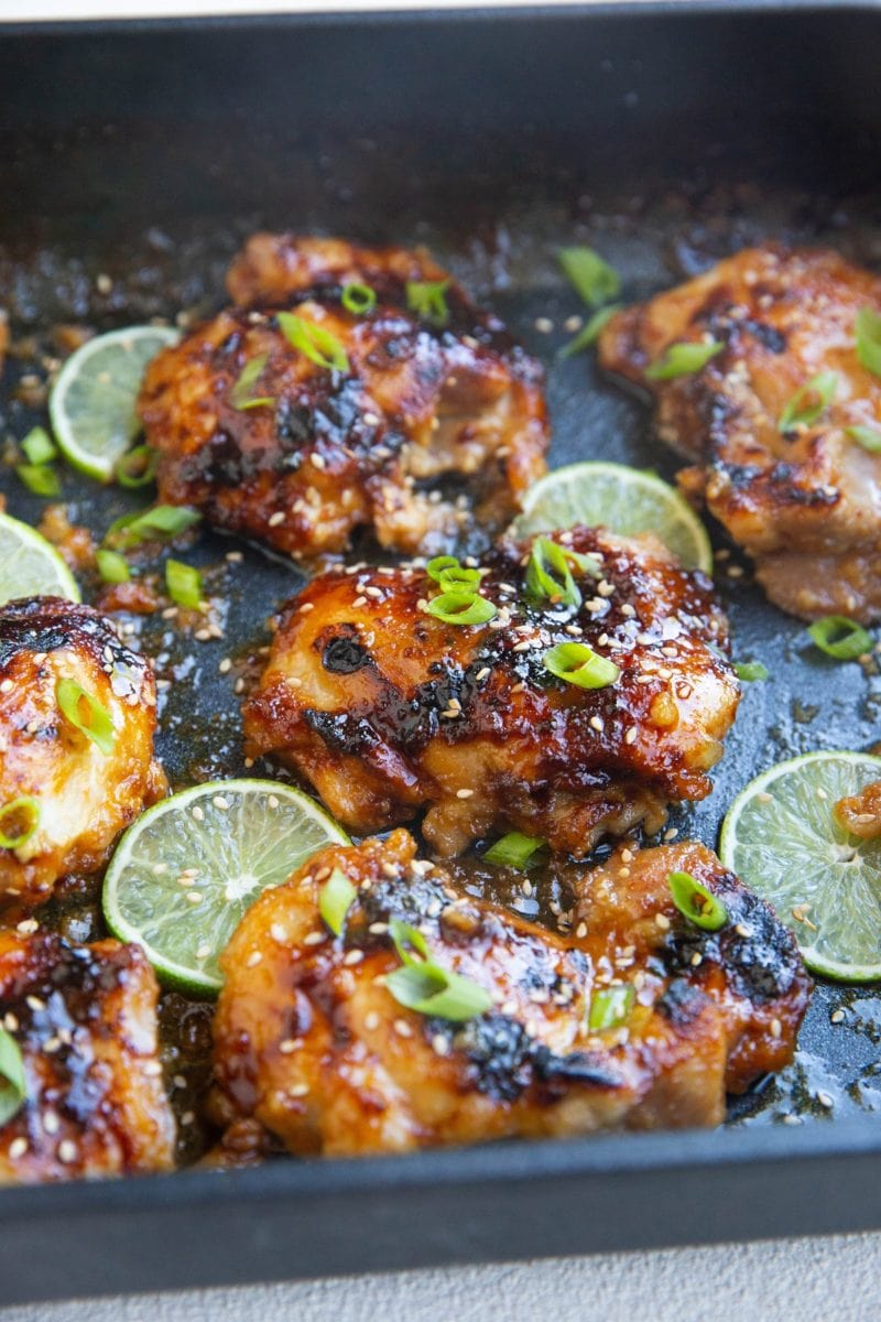 Close up shot of honey lime chicken thigh in a casserole dish.