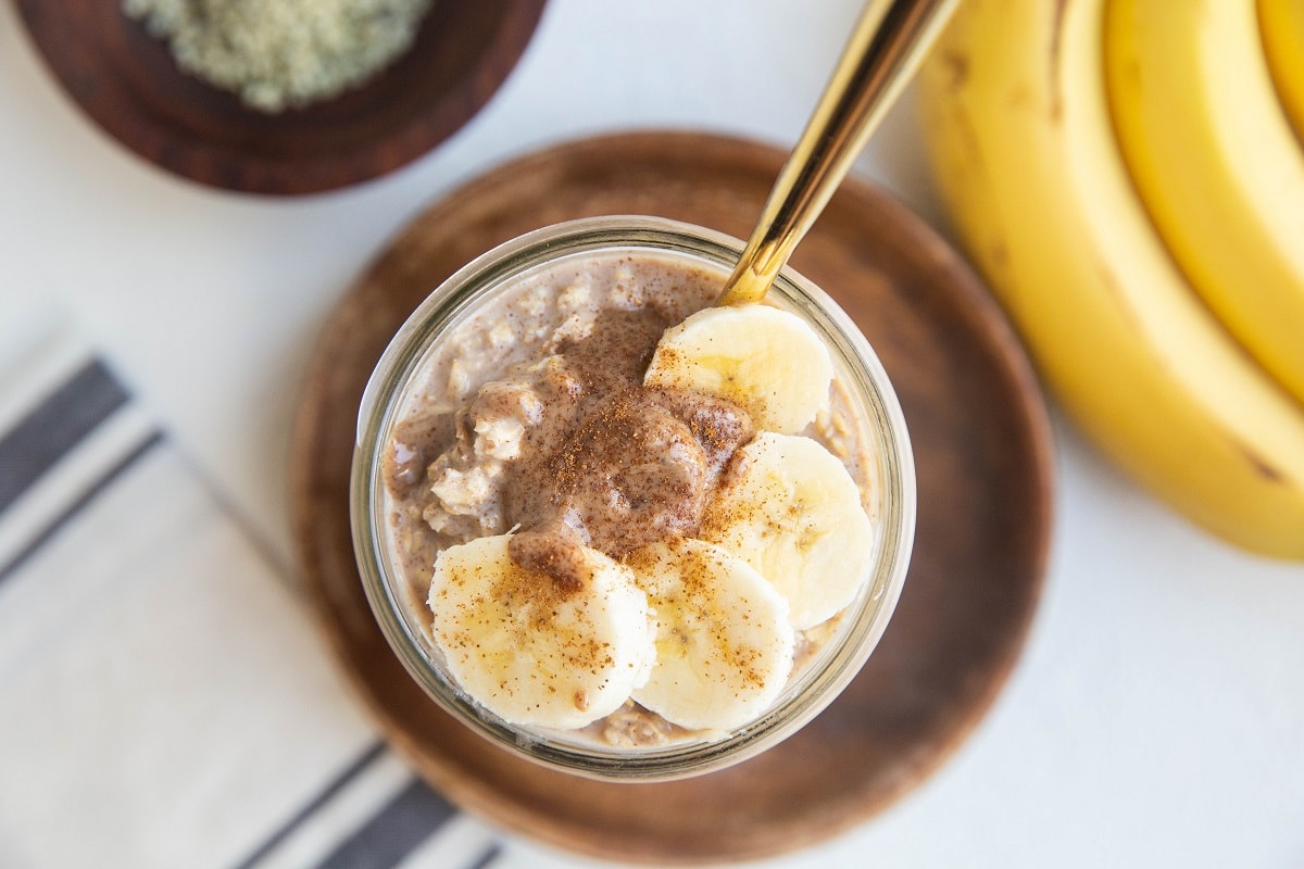jar of oatmeal with almond butter and banana on top.