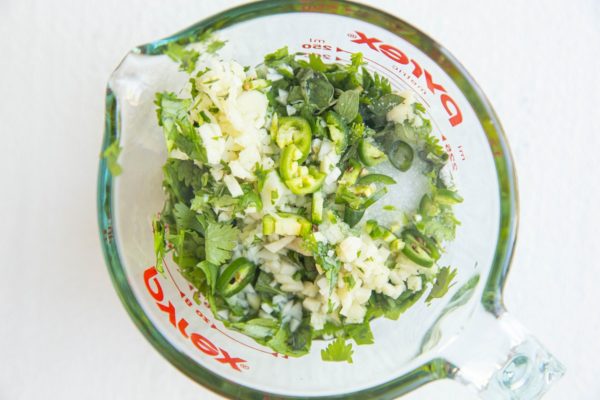 Ingredients for chimichurri sauce in a measuring cup.