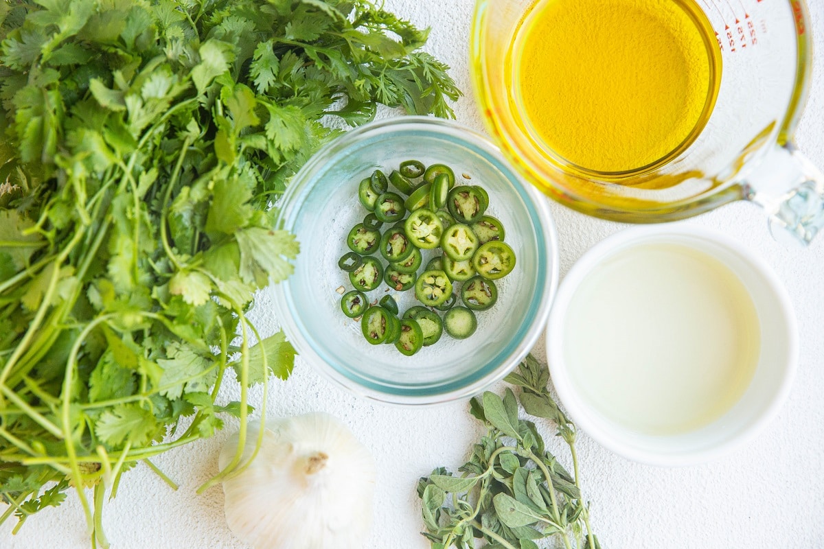 Ingredients for chimichurri sauce on a white background.