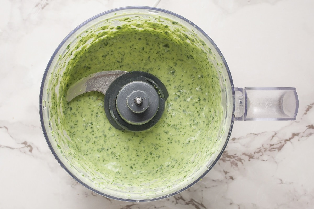 Finished green goddess dressing in a food processor.