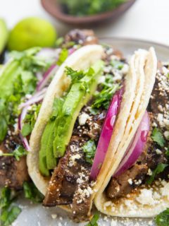 Flank steak tacos on a plate.