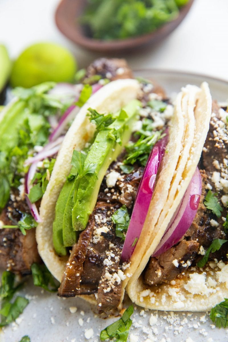 Flank steak tacos on a plate.