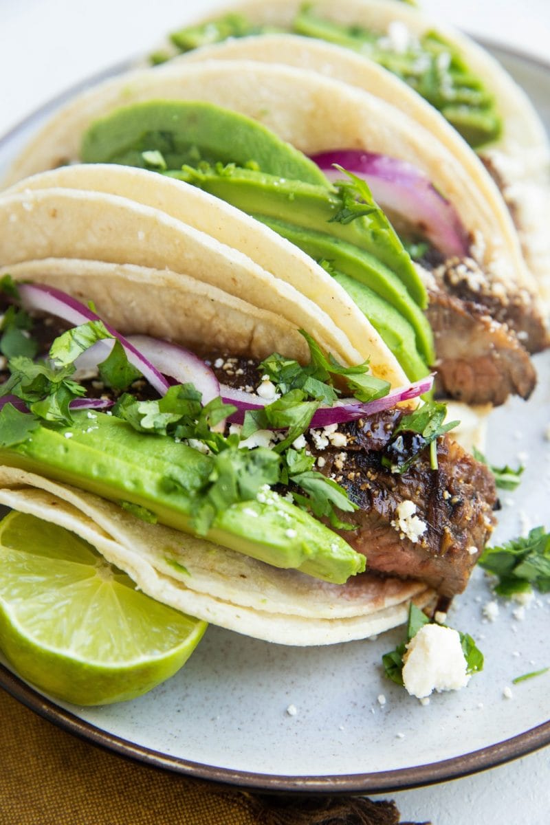 three beef tacos on a plate