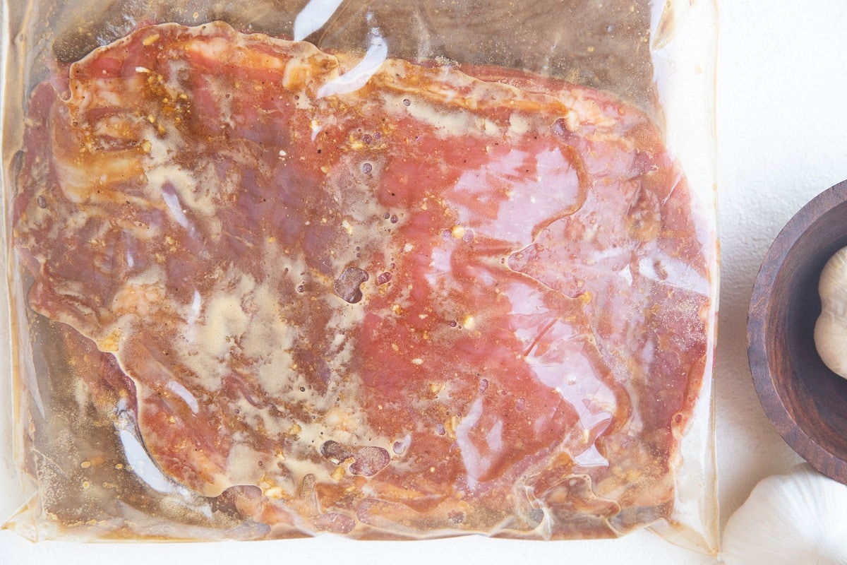 Flank steak marinating in a zip lock bag