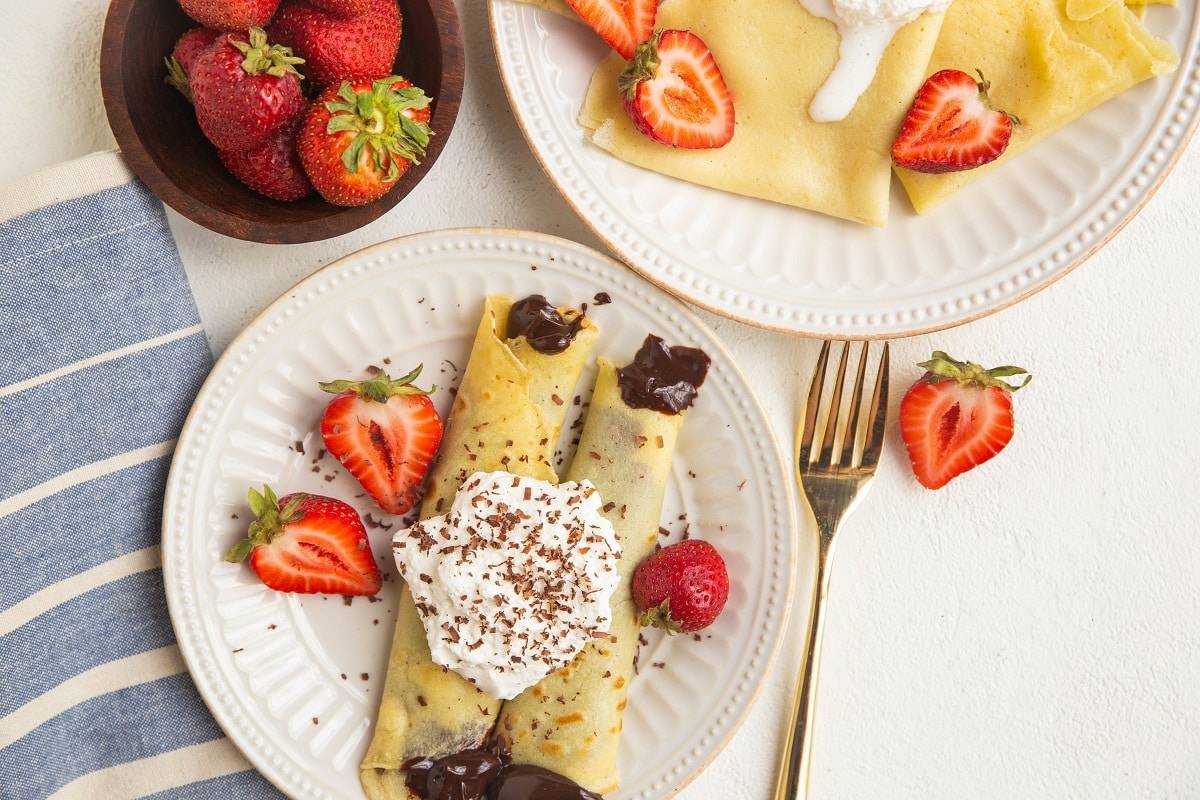horizontal photo of two plates of crepes