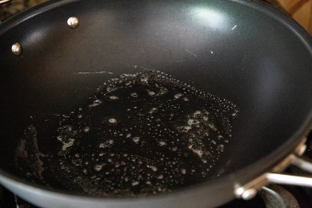Nonstick skillet with bubbling butter inside.