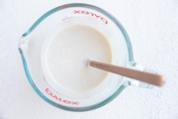 Coleslaw dressing in a measuring cup