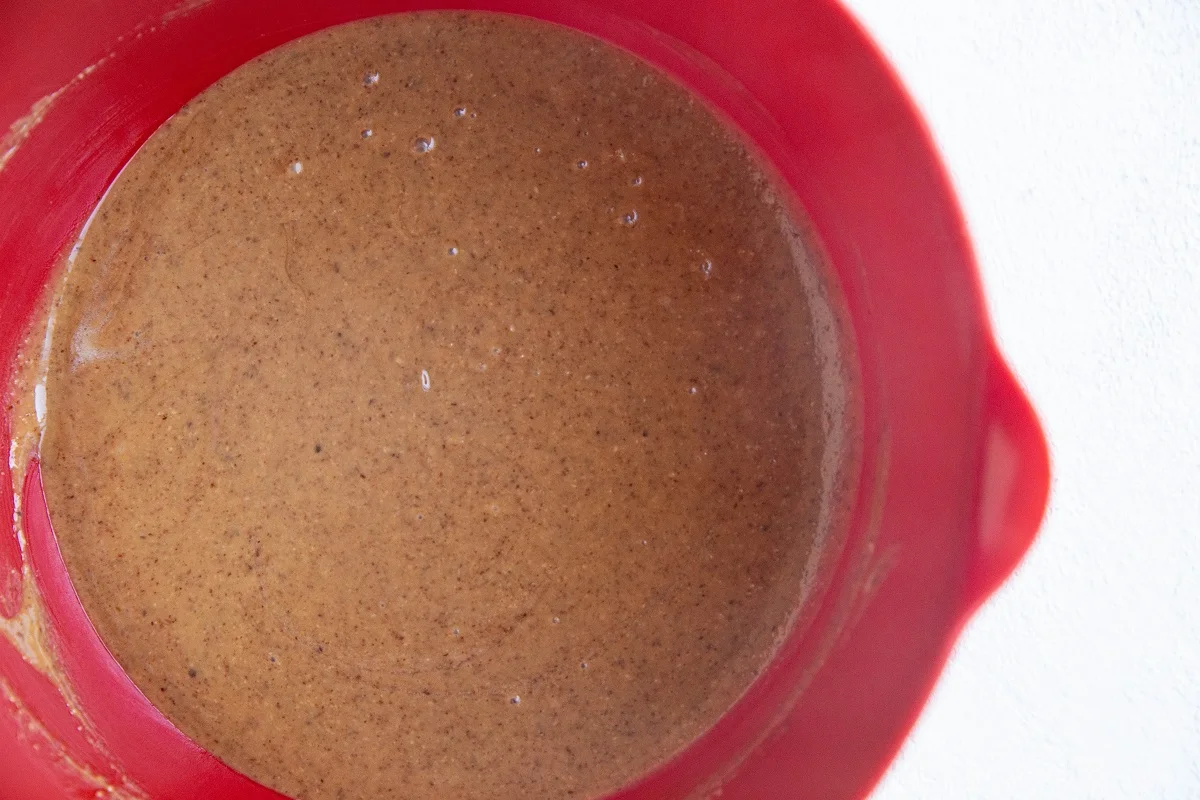 Wet ingredients for rice krispie treats stirred together in a bowl.