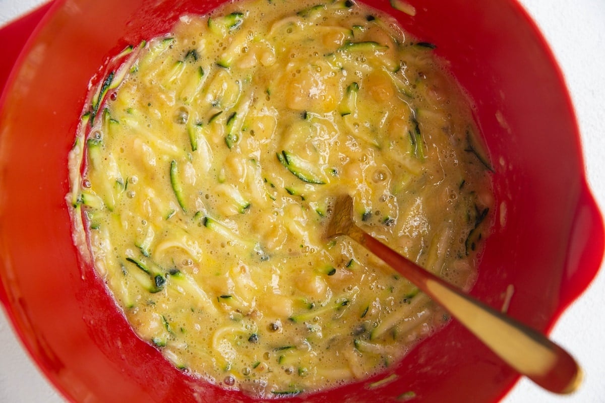 Wet ingredients for banana zucchini bread in a mixing bowl.