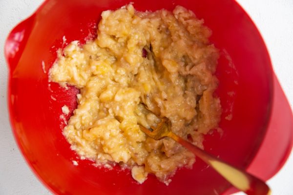 Mashed bananas in a mixing bowl.