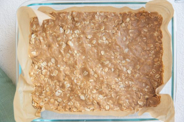 Oatmeal peanut butter mixture in a pan.