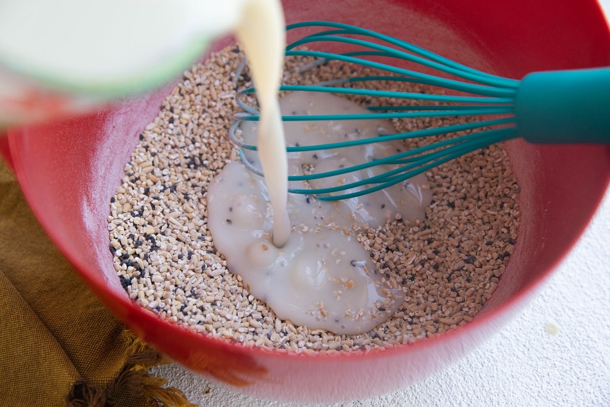 Milk being poured into the bowl with the oats.