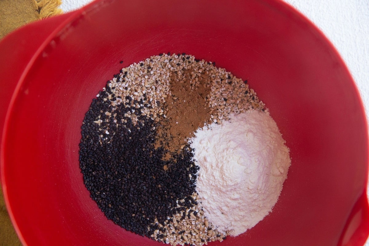 mixing bowl with oats, chia seeds, protein powder, and cinnamon.