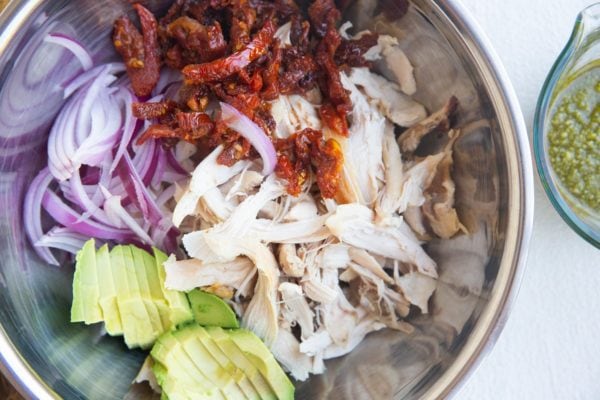 Ingredients for chicken salad in a mixing bowl