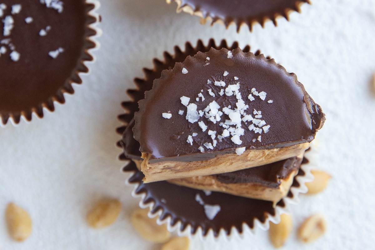 horizontal photo of sliced peanut butter cup on top of another peanut butter cup