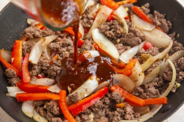 Pouring sauce into a skillet