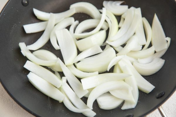 Onions sautéing in a skillet.