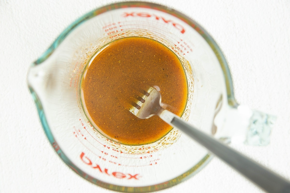 seasonings for curry cauliflower all mixed up in a measuring cup.