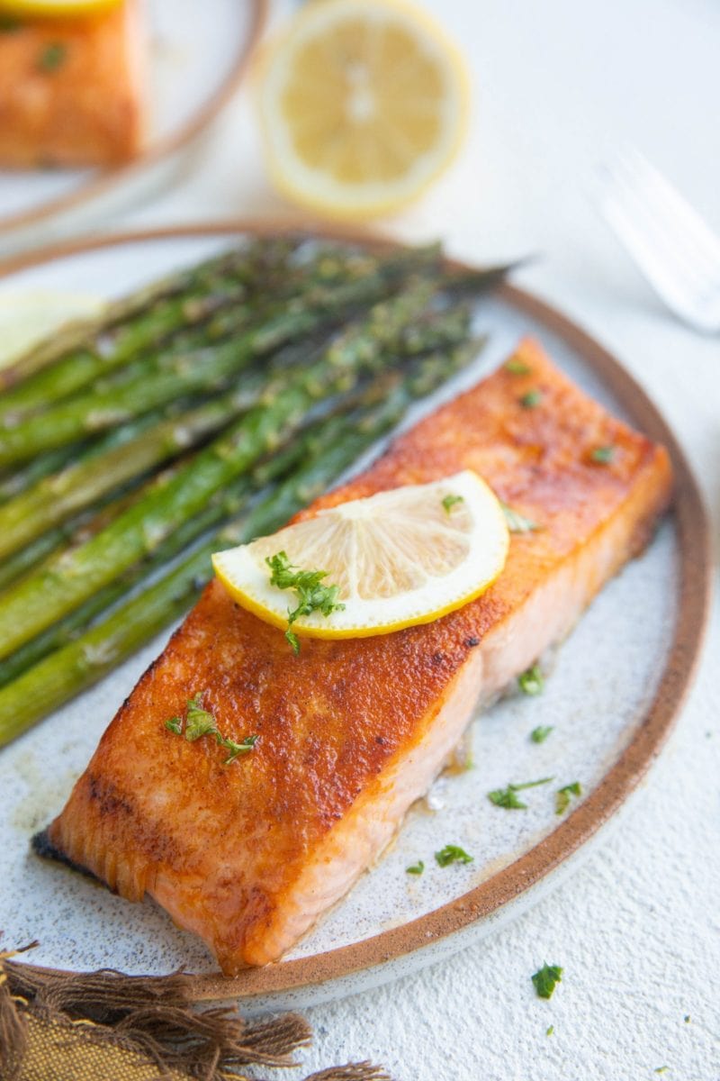 Salmon filet on a plate with roasted asparagus