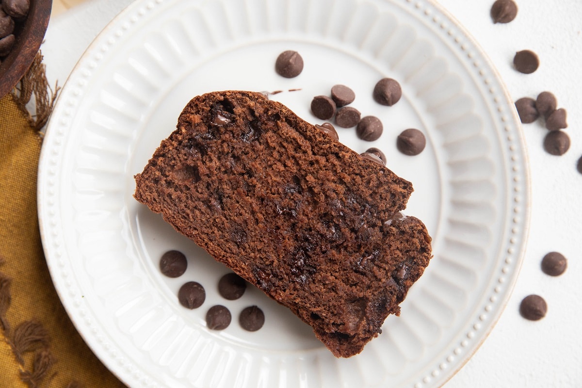 Close up horizontal shot of a slice of banana bread on a plate.