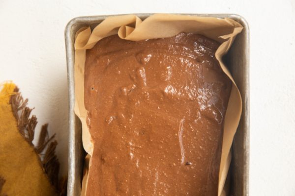 Chocolate banana bread batter in a loaf pan.