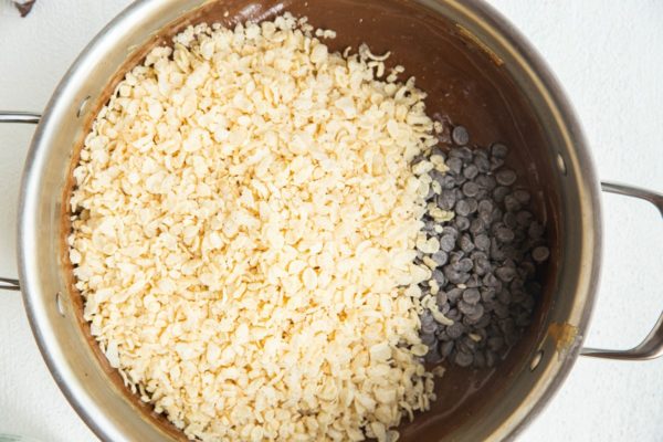 Wet ingredients in the pot with crispy rice cereal and chocolate chips