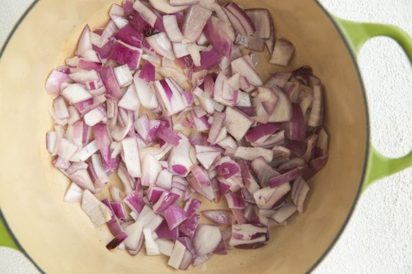 Onion sautéing in a large pot.