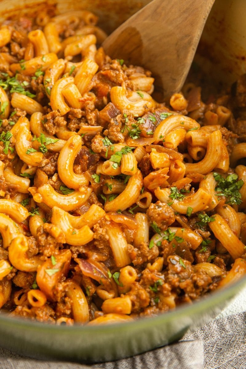 Finished Hamburger Helper in a pot with parsley sprinkled on top.