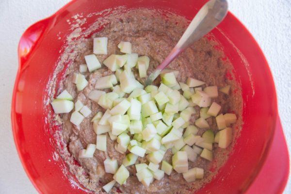 Apple muffin batter with fresh apples ready to be mixed in