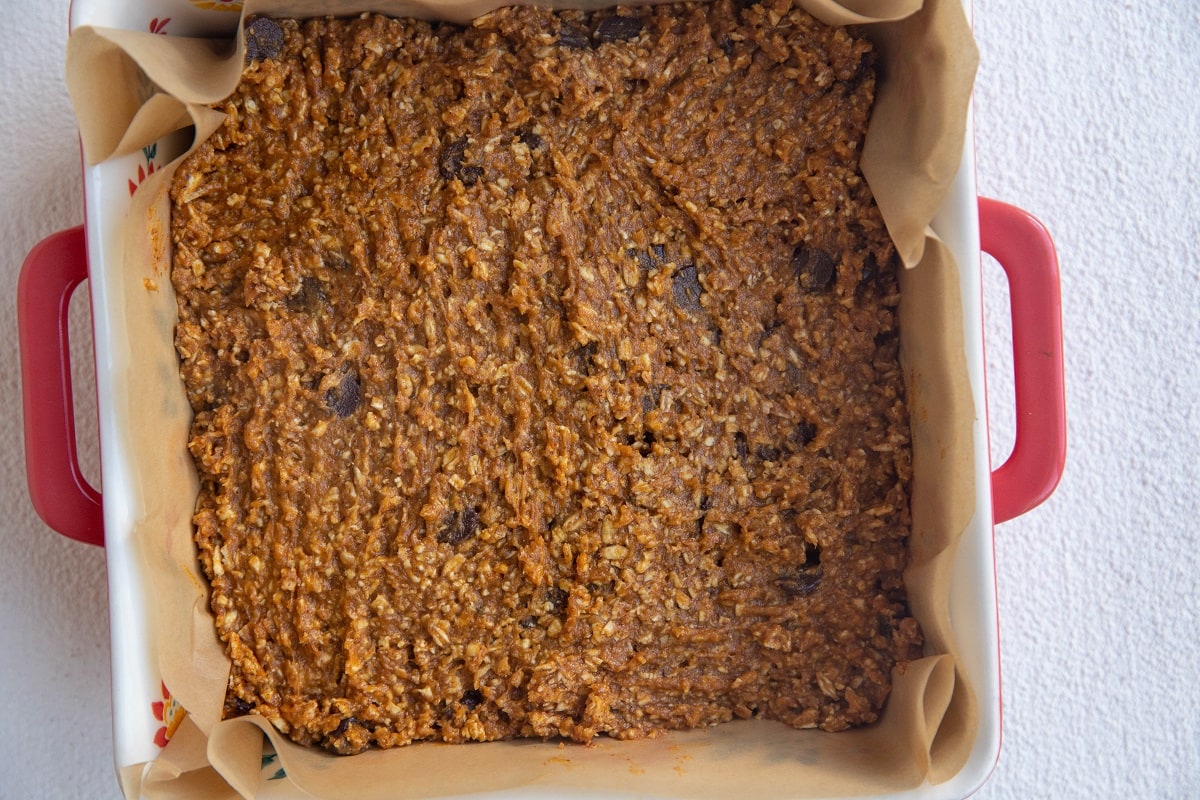 Baking dish with pumpkin bar mixture spread in it, ready to go into the oven.